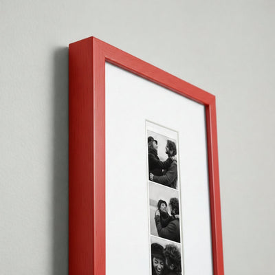 Photo strip in a red wood frame