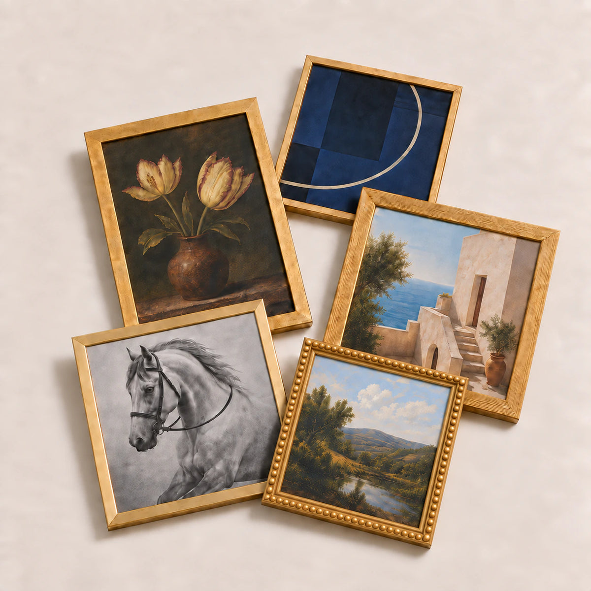 A collection of gold picture frames lying flat with varied edge-to-edge artwork