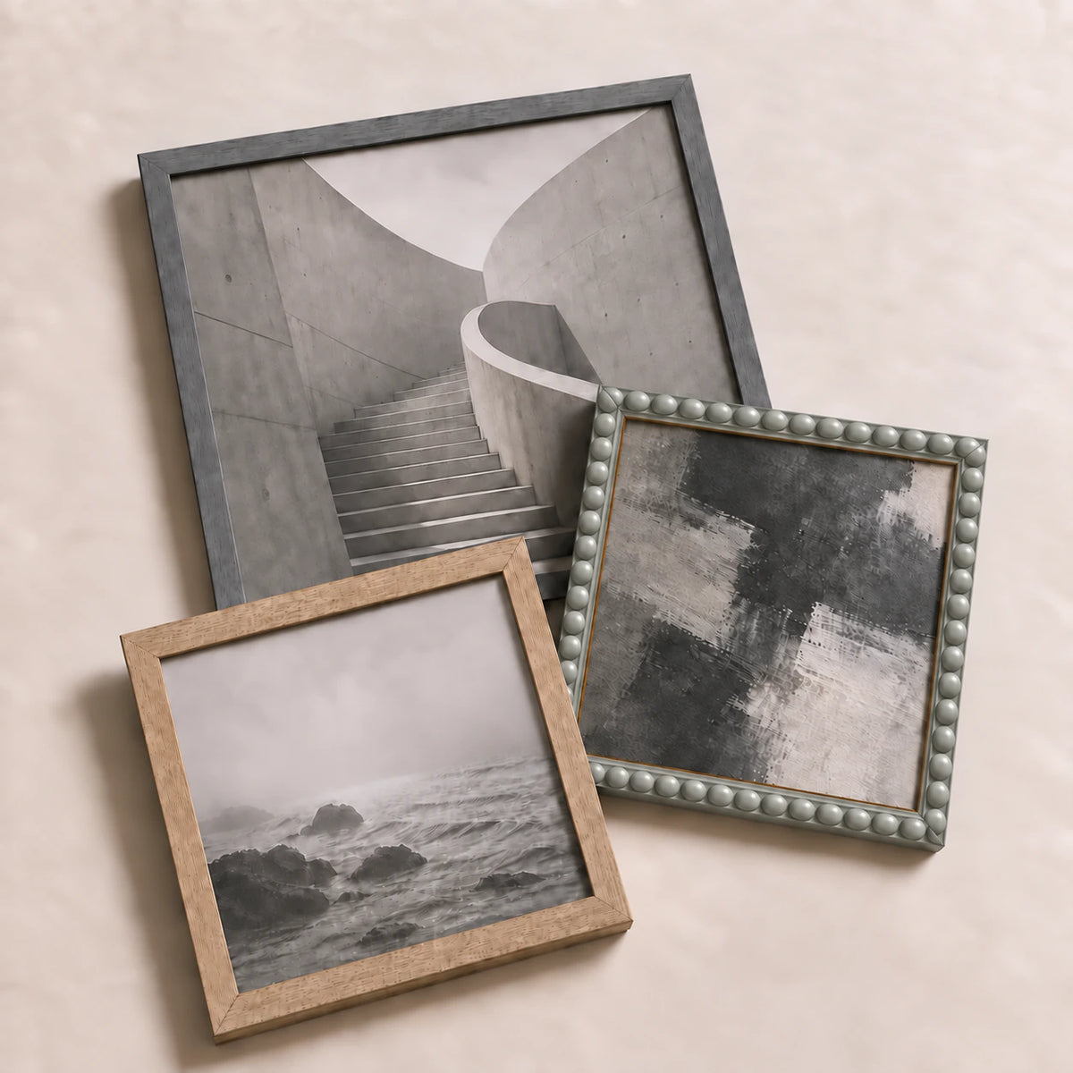 A collection of grey picture frames lying flat with varied edge-to-edge artwork