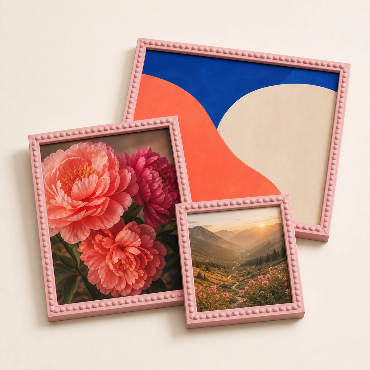 A collection of pink bobbin picture frames lying flat with varied edge-to-edge artwork