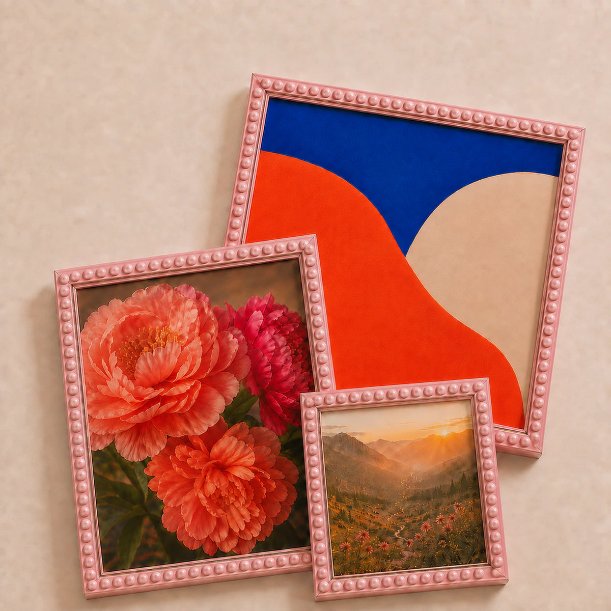 A collection of pink bobbin picture frames lying flat with varied edge-to-edge artwork