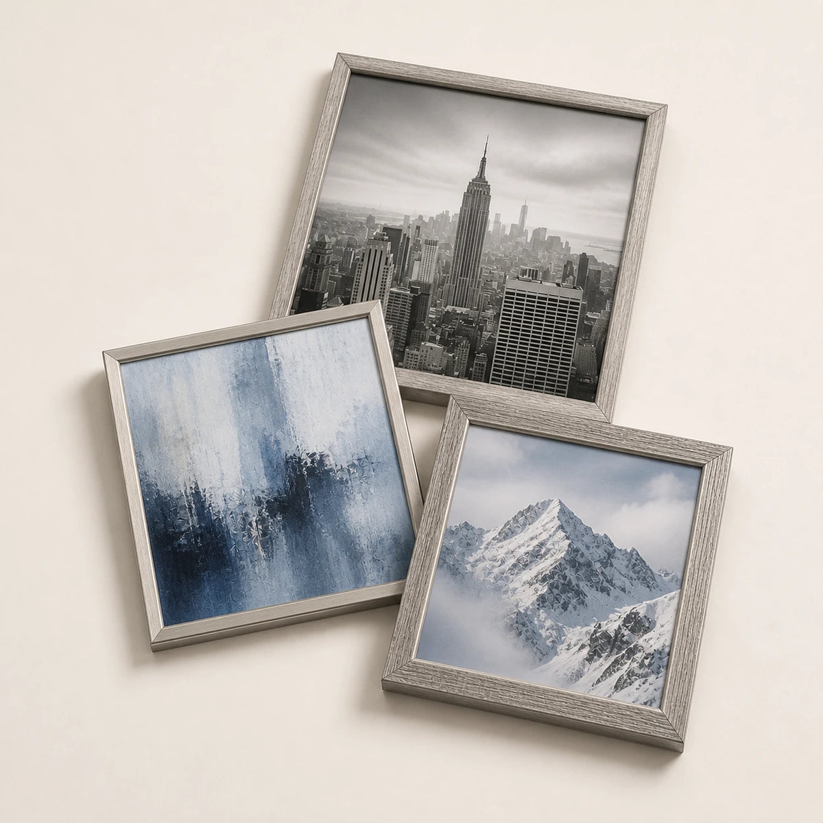 A collection of silver picture frames lying flat with varied edge-to-edge artwork