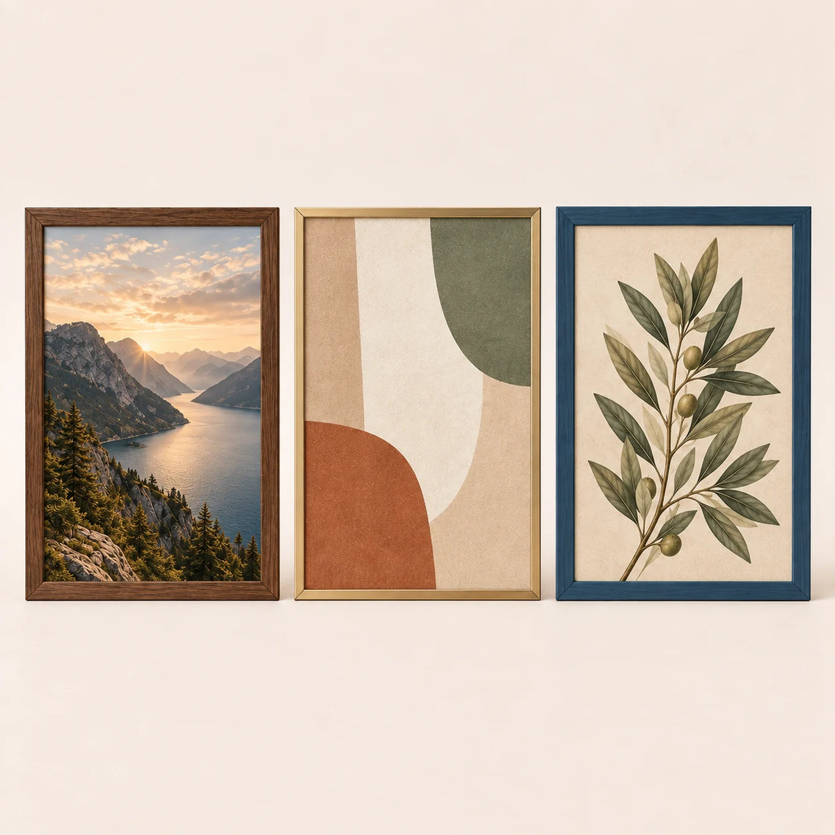 Three 16 by 22 inch picture frames in walnut, champagne brass and slate blue finishes with varied artwork