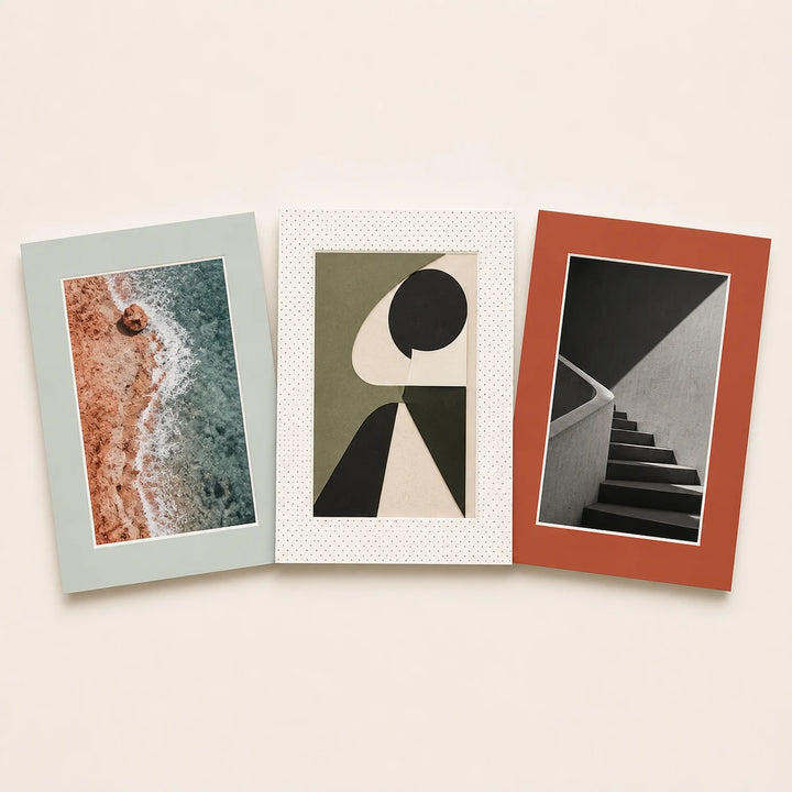 Three 13 by 19 inch picture mats in plain and patterned finishes holding varied artwork