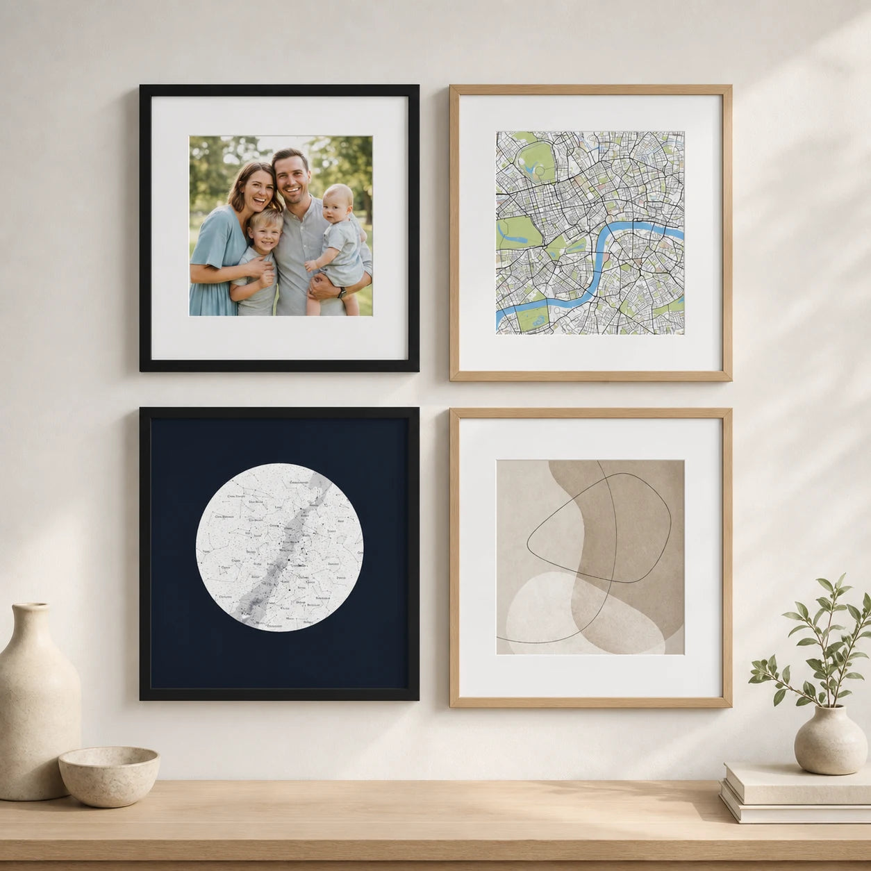 A gallery wall of framed photographs, maps, star maps and abstract art