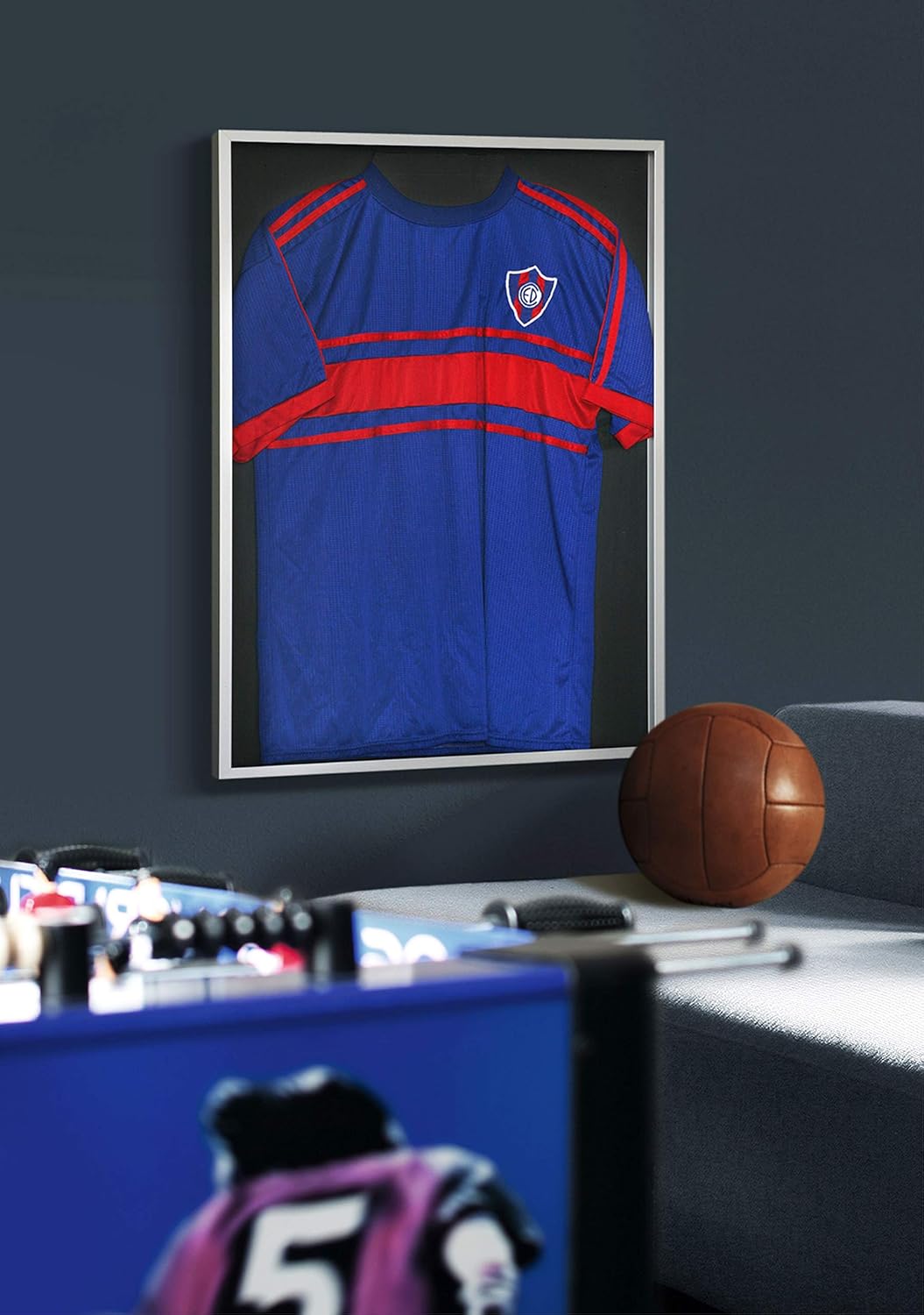 Framed soccer jersey on wall