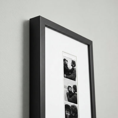 Photo strip in a black wood frame