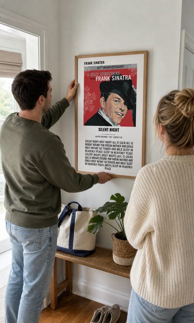 Couple hanging a personalised Silent Night album artwork lyrics print
