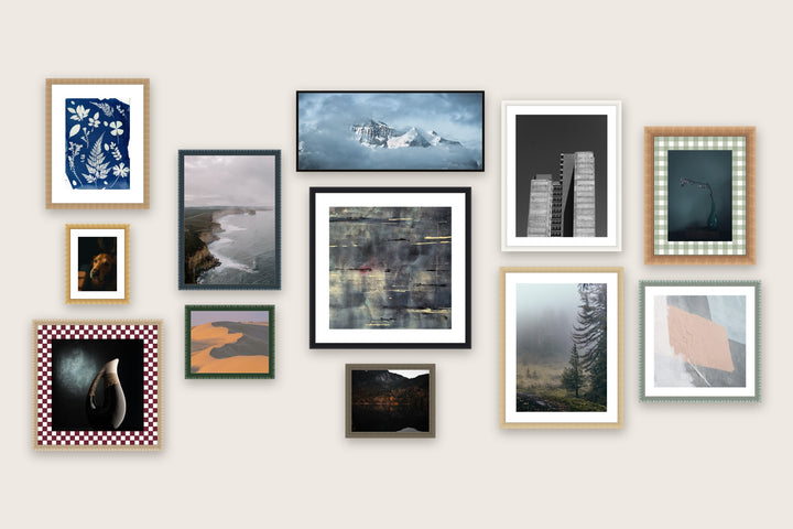 Gallery wall of twelve made-to-measure picture frames in mixed sizes, mouldings and mat boards
