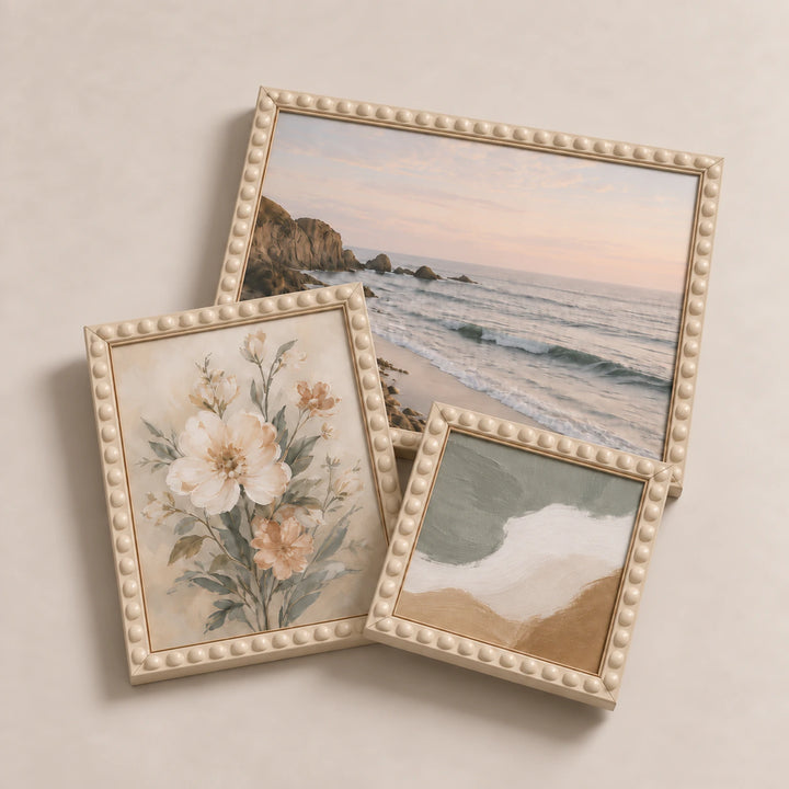 A collection of cream bobbin picture frames lying flat with varied edge-to-edge artwork