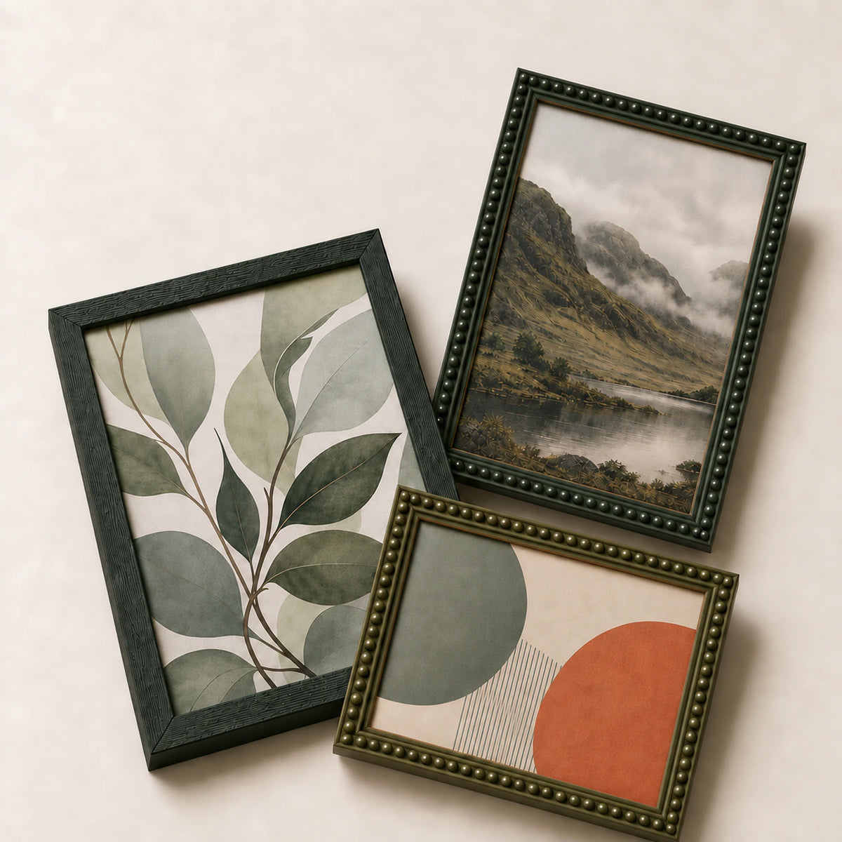 A collection of green picture frames lying flat with varied edge-to-edge artwork
