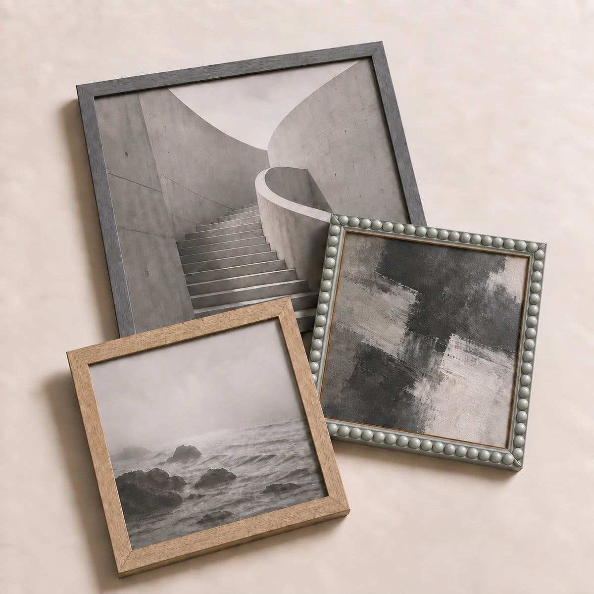 A collection of grey picture frames lying flat with varied edge-to-edge artwork