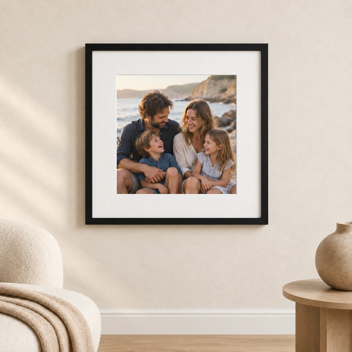 A black framed and mounted family photograph displayed on a warm neutral wall