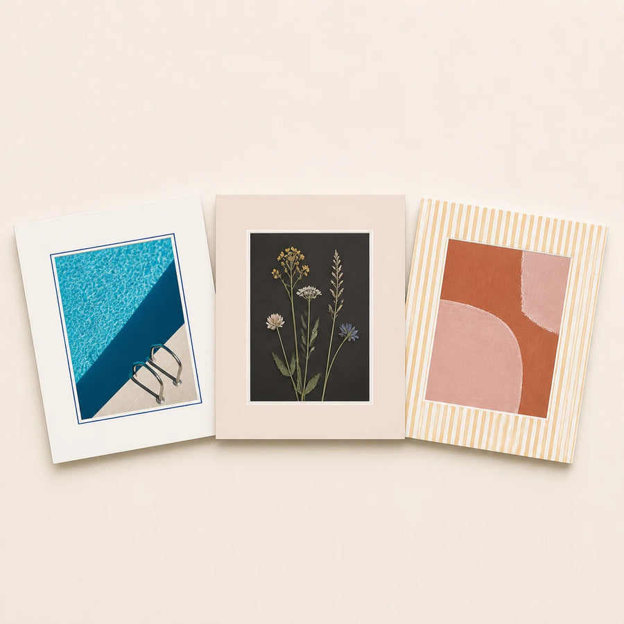 Three 5 by 7 inch picture mats in plain and patterned finishes holding varied artwork