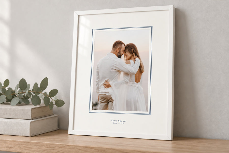 White frame with a navy French line around the wedding photo and the names printed on the mat